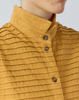Close-up of the short stand-up cotton lawn collar and jersey pintucks on the Yaccomaricard Kantan Waistcoat.
