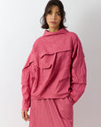 Front view of the Yaccomaricard 1023998 pintuck top in Dust Rose, featuring a relaxed A-line silhouette, high neckline, and the brand's signature all-over vertical pintuck detailing.