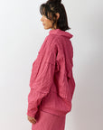 Side profile of the 1023998 Shibo top showing the generous, comfortable "off-body" fit and the fluid drape of the hemline, illustrating how it fits different body types.