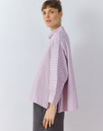 Side profile of Sode Jersey Pullover showing architectural draped sleeve detail in lilac purple.
