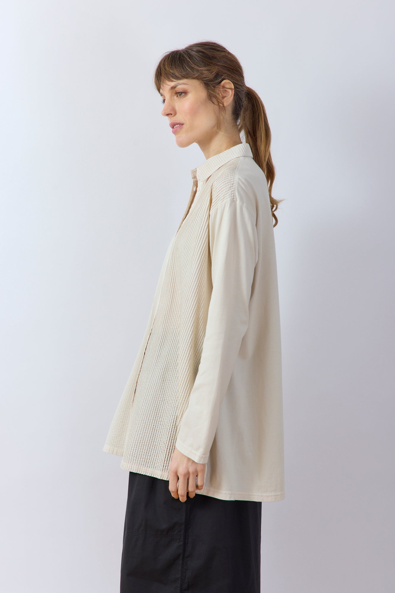 Side profile of the Jasmine White Cotton Lawn Overshirt showing the longline silhouette and side vents.