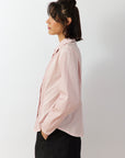 Side profile of the Sakura Wanda Shirt showing the softly curved seams and elegant fluid silhouette.