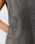 Side view of the YaccoMaricard longline top, highlighting the seamless transition of the textured stitching and the discreet, practical inseam side pockets.