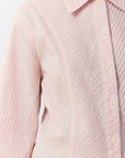 Detail shot of the garment-dyed cotton lawn and tailored sleeves with refined cuffs in Sakura.
