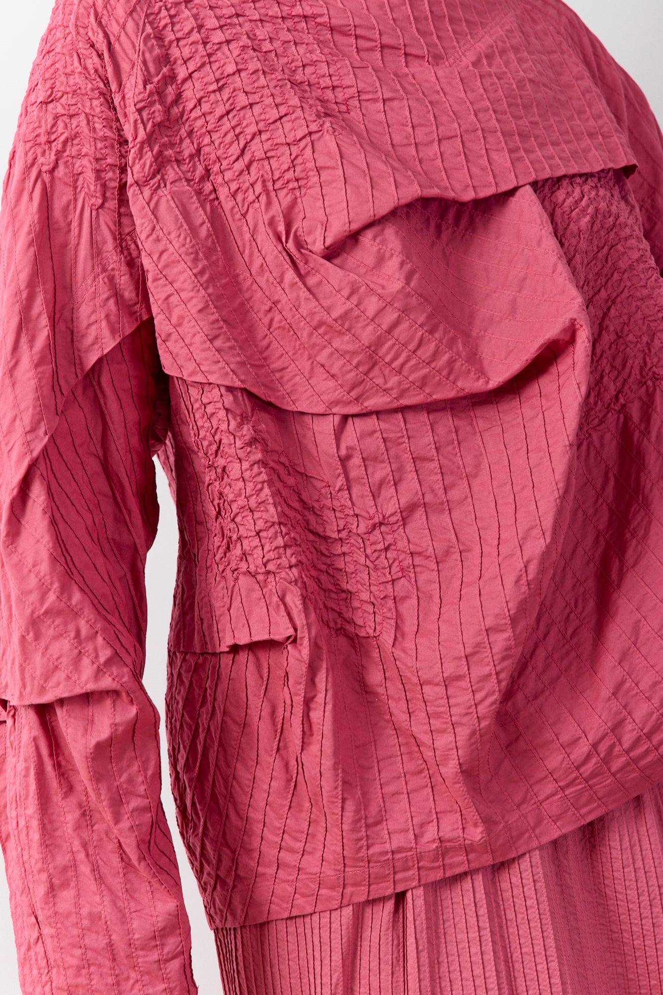 Another close up of the fabric and texture of the Shibo Top in Dust Rose, shaping an elegant off-body silhouette that drapes effortlessly without clinging.