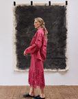 Model wearing Kazari Skirt in Dust Rose styled with minimalist top showing relaxed elegance.